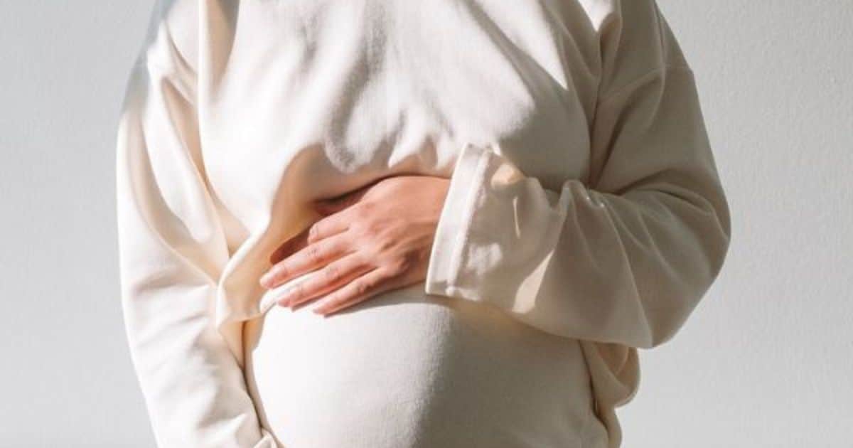 pregnant woman holding belly