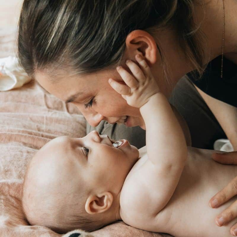 new mom face to face with newborn baby bonding